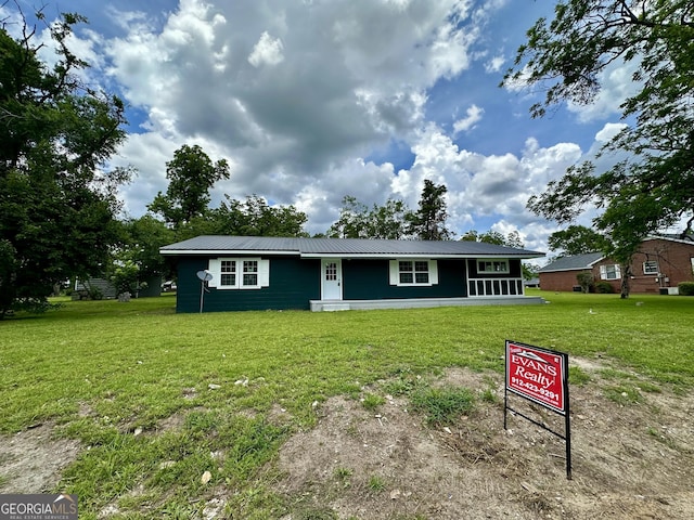 210 W Graham St, Mcrae-Helena, GA 31055 - view of front of house featuring a front yard and a metal roof
