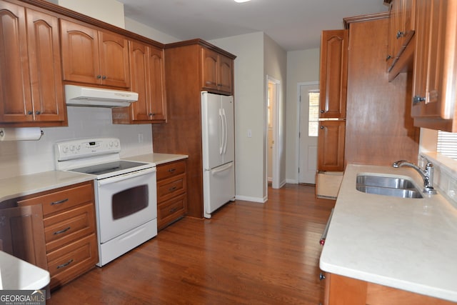 195 Twin Oaks Dr, Hampton, GA 30228 - kitchen with white appliances, under cabinet range hood, dark wood finished floors, backsplash, and light countertops