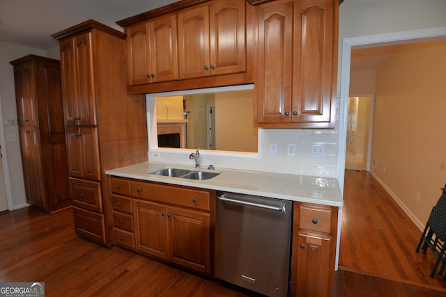 195 Twin Oaks Dr, Hampton, GA 30228 - kitchen featuring stainless steel dishwasher, brown cabinetry, dark wood-style flooring, and light countertops