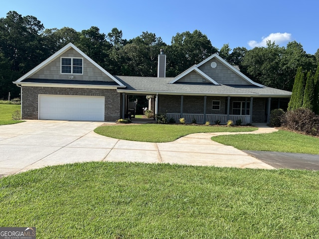 195 Twin Oaks Dr, Hampton, GA 30228 - view of front facade featuring covered porch, driveway, a front yard, and a chimney