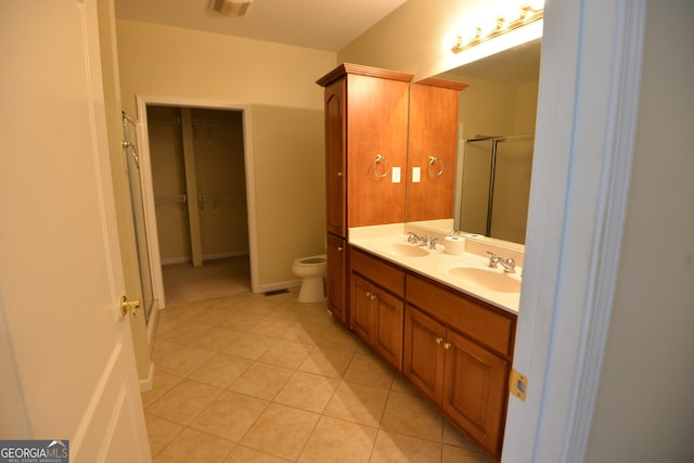 195 Twin Oaks Dr, Hampton, GA 30228 - bathroom featuring double vanity, tile patterned floors, a shower stall, and a walk in closet