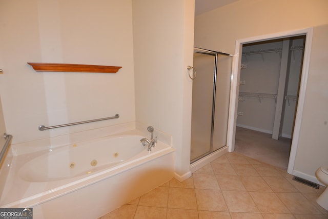 195 Twin Oaks Dr, Hampton, GA 30228 - bathroom with a jetted tub, a stall shower, a spacious closet, and tile patterned floors