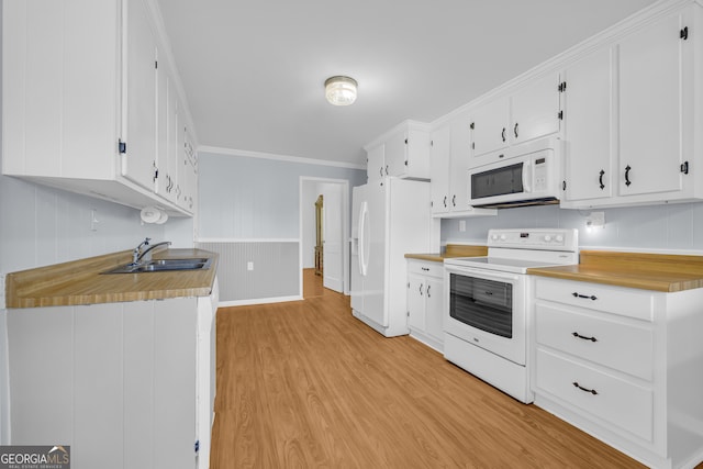 303 Oak Way Dr, Eastanollee, GA 30538 - kitchen with white appliances, light wood finished floors, white cabinets, ornamental molding, and light countertops