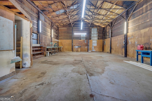 303 Oak Way Dr, Eastanollee, GA 30538 - miscellaneous room featuring a garage, unfinished concrete floors, and vaulted ceiling