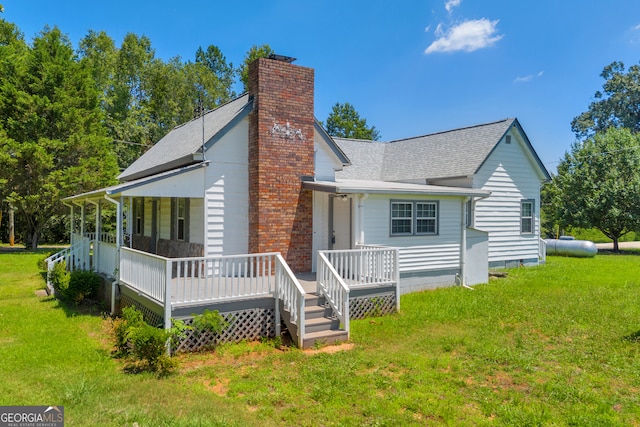 303 Oak Way Dr, Eastanollee, GA 30538 - view of front of home featuring a chimney, a front yard, roof with shingles, and a porch
