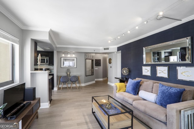 795 Hammond Dr Unit 1012, Atlanta, GA 30328 - living area with an accent wall, light wood-type flooring, arched walkways, and crown molding