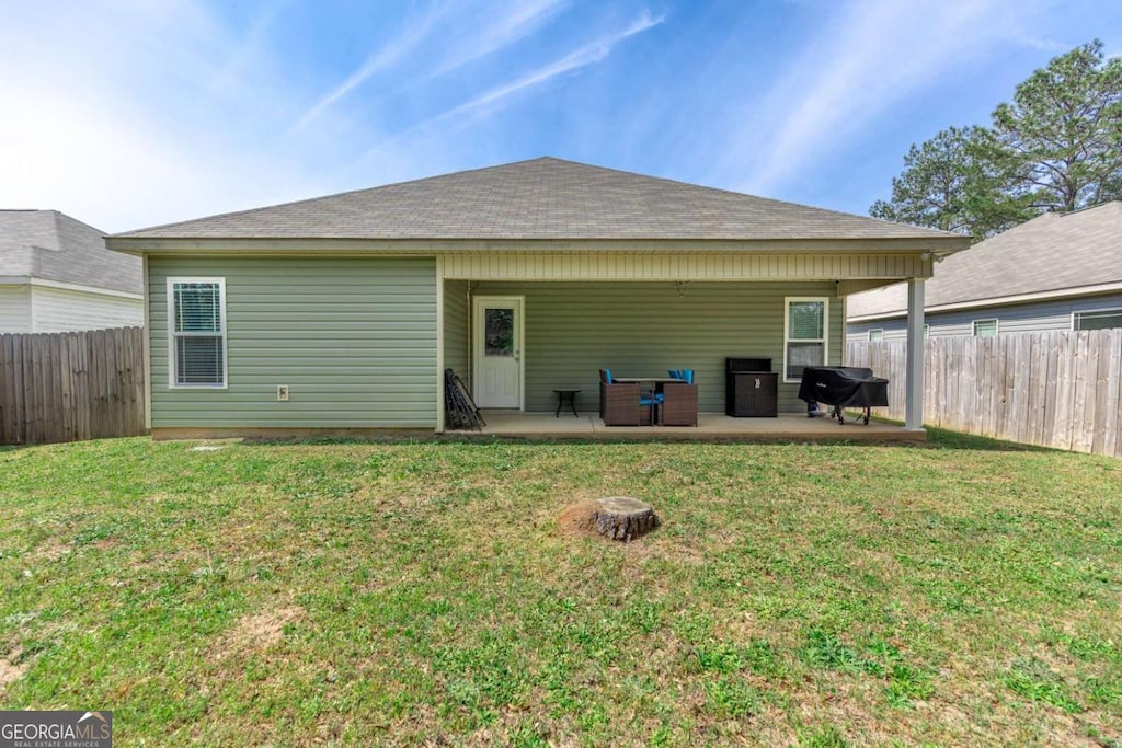 104 Hughes Dr, Warner Robins, GA 31093 - rear view of house featuring a patio area and a fenced backyard