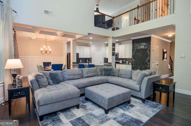 2436 Loughridge Dr, Buford, GA 30519 - living room featuring dark wood-style flooring, a chandelier, beamed ceiling, coffered ceiling, and a towering ceiling
