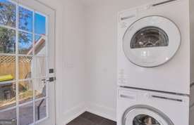 1016 Seiler Ave, Savannah, GA 31401 - laundry room featuring stacked washer / drying machine and baseboards