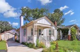 1016 Seiler Ave, Savannah, GA 31401 - bungalow-style house with an outbuilding, a chimney, a front lawn, and concrete driveway