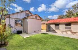 1016 Seiler Ave, Savannah, GA 31401 - rear view of property featuring a patio area, a lawn, and a storage unit