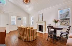 1016 Seiler Ave, Savannah, GA 31401 - living room with plenty of natural light, wood finished floors, lofted ceiling, and a fireplace