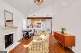 1016 Seiler Ave, Savannah, GA 31401 - living area with wood finished floors, a fireplace with raised hearth, and lofted ceiling