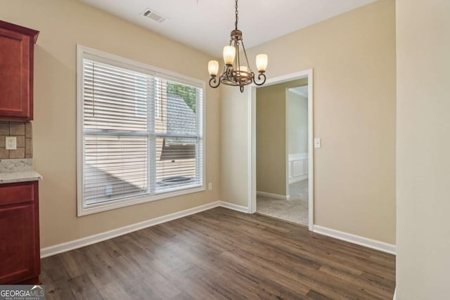 1755 Rutland Pass Dr, Lawrenceville, GA 30045 - unfurnished dining area featuring a chandelier and dark wood-type flooring
