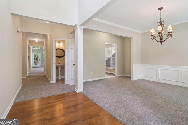 1755 Rutland Pass Dr, Lawrenceville, GA 30045 - carpeted spare room with a chandelier, crown molding, and wood finished floors