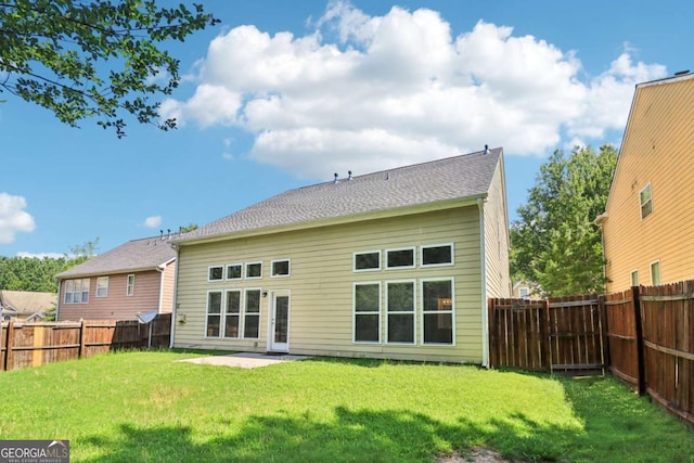 1755 Rutland Pass Dr, Lawrenceville, GA 30045 - back of property with a fenced backyard and a patio