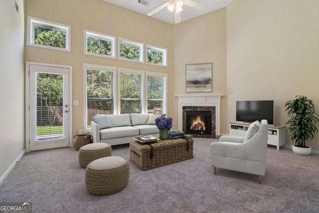 1755 Rutland Pass Dr, Lawrenceville, GA 30045 - carpeted living room with a high ceiling, ceiling fan, a high end fireplace, and healthy amount of natural light