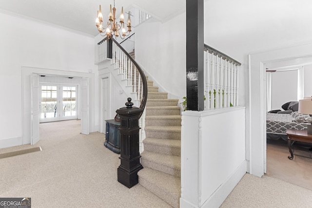 2540 Sugar Hill Rd, Unadilla, GA 31091 - staircase featuring carpet flooring, a chandelier, ornamental molding, and a towering ceiling