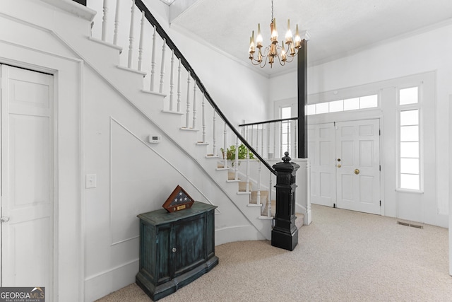 2540 Sugar Hill Rd, Unadilla, GA 31091 - foyer featuring carpet floors, a chandelier, crown molding, and stairway
