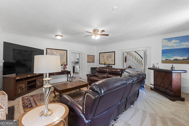 2540 Sugar Hill Rd, Unadilla, GA 31091 - living area featuring stairs, a textured ceiling, a ceiling fan, ornamental molding, and carpet floors