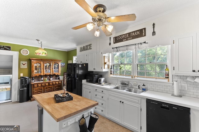 2540 Sugar Hill Rd, Unadilla, GA 31091 - kitchen featuring black appliances, a textured ceiling, a ceiling fan, decorative backsplash, and white cabinetry