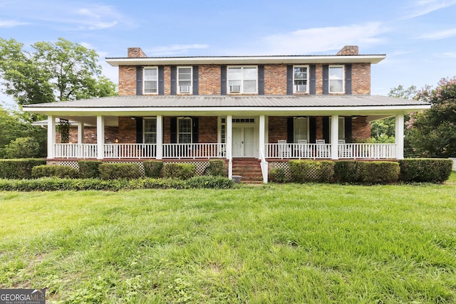 2540 Sugar Hill Rd, Unadilla, GA 31091 - view of front facade featuring a chimney, brick siding, covered porch, and a front lawn