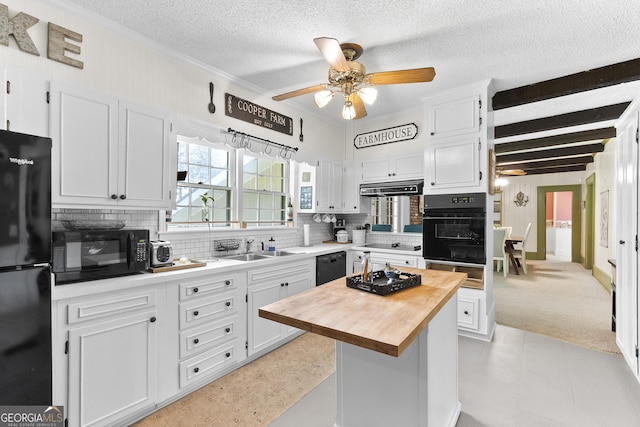 2540 Sugar Hill Rd, Unadilla, GA 31091 - kitchen with black appliances, butcher block counters, ceiling fan, backsplash, and under cabinet range hood