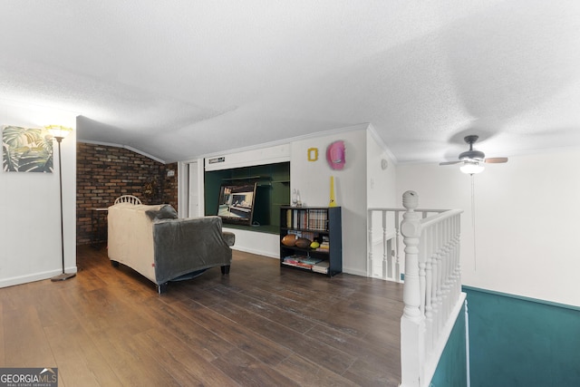 2540 Sugar Hill Rd, Unadilla, GA 31091 - living area with a textured ceiling, wood finished floors, brick wall, ceiling fan, and crown molding