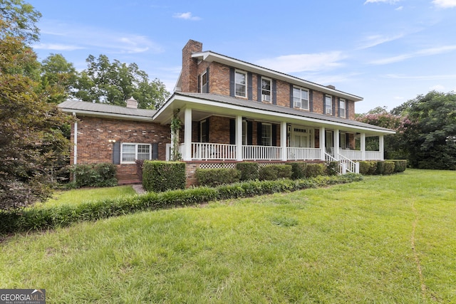 2540 Sugar Hill Rd, Unadilla, GA 31091 - view of front of house featuring a chimney, brick siding, covered porch, a front yard, and a metal roof