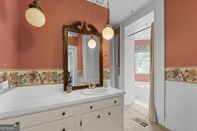 2540 Sugar Hill Rd, Unadilla, GA 31091 - full bathroom with vanity, a wainscoted wall, and a bath