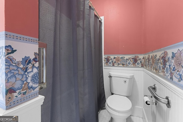 2540 Sugar Hill Rd, Unadilla, GA 31091 - full bathroom with a wainscoted wall, tile patterned floors, and a shower with shower curtain