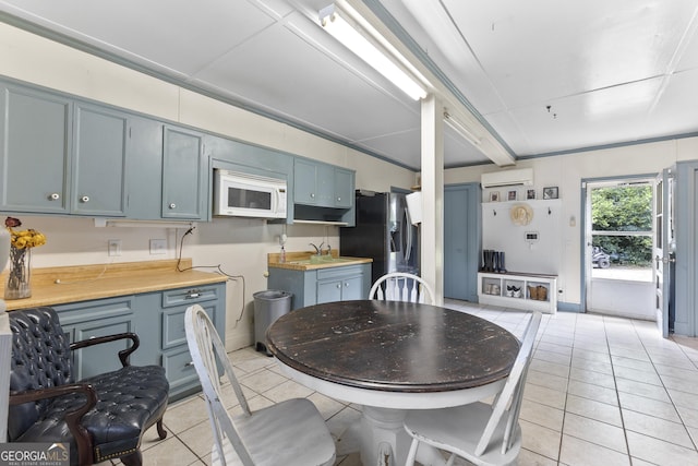 2540 Sugar Hill Rd, Unadilla, GA 31091 - dining area with a wall mounted air conditioner and light tile patterned floors