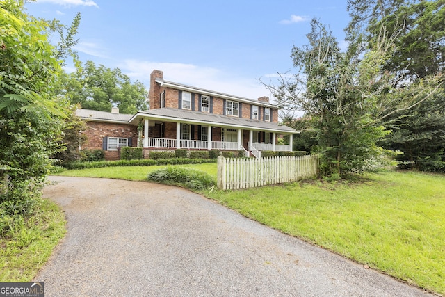 2540 Sugar Hill Rd, Unadilla, GA 31091 - view of front of property with a chimney, covered porch, brick siding, and driveway