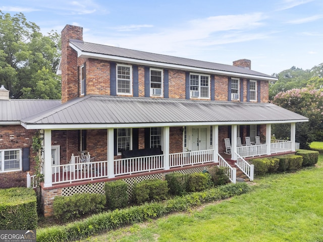2540 Sugar Hill Rd, Unadilla, GA 31091 - farmhouse featuring a chimney, covered porch, and brick siding