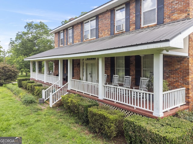 2540 Sugar Hill Rd, Unadilla, GA 31091 - farmhouse inspired home featuring a porch, brick siding, and a metal roof