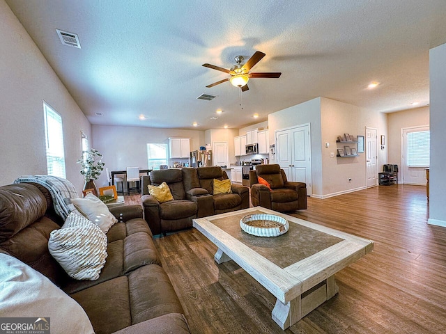 534 Meadows Farm Dr, Monroe, GA 30655 - living area with healthy amount of natural light, a ceiling fan, wood finished floors, and a textured ceiling