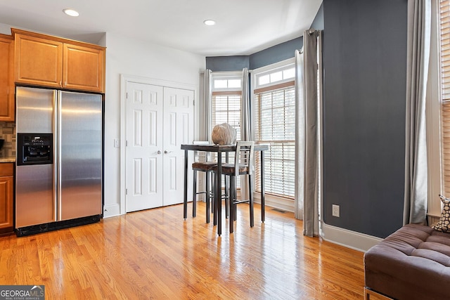 196 Mystic Ct, Atlanta, GA 30342 - kitchen featuring stainless steel refrigerator with ice dispenser, light wood finished floors, recessed lighting, and brown cabinets