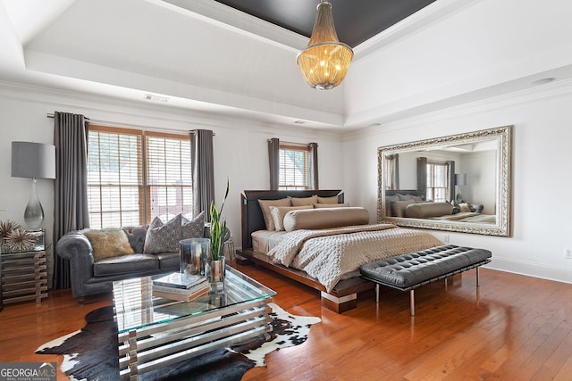 196 Mystic Ct, Atlanta, GA 30342 - bedroom featuring a tray ceiling, crown molding, hardwood / wood-style flooring, and a chandelier