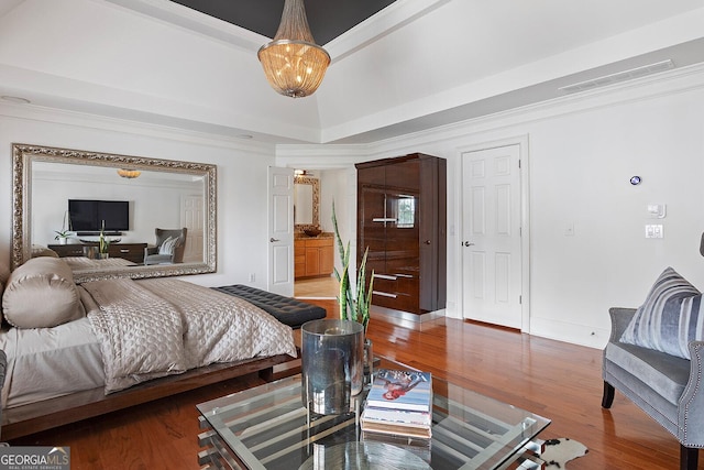 196 Mystic Ct, Atlanta, GA 30342 - bedroom with crown molding, a tray ceiling, and wood finished floors