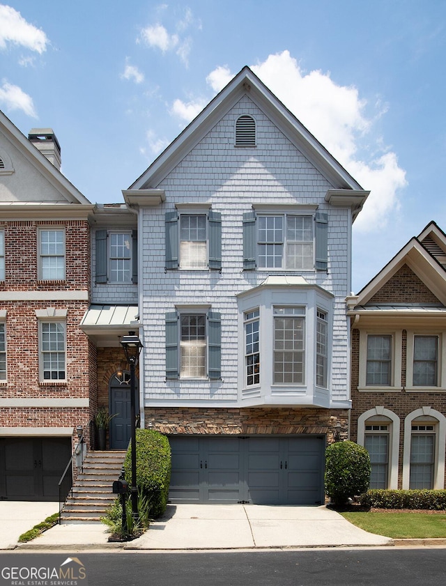 196 Mystic Ct, Atlanta, GA 30342 - townhome / multi-family property featuring concrete driveway and a garage