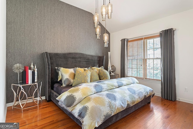 196 Mystic Ct, Atlanta, GA 30342 - bedroom with wood-type flooring and vaulted ceiling