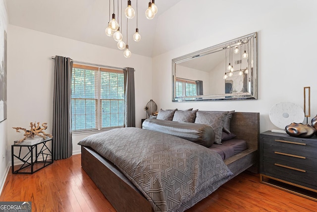 196 Mystic Ct, Atlanta, GA 30342 - bedroom with vaulted ceiling, multiple windows, and wood-type flooring