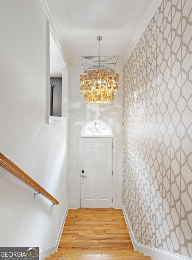 196 Mystic Ct, Atlanta, GA 30342 - foyer featuring a chandelier, light wood-type flooring, wallpapered walls, and ornamental molding