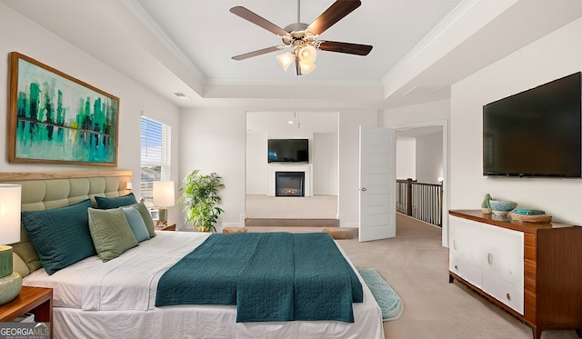 683 Edgar, Hampton, GA 30228 - carpeted bedroom featuring a raised ceiling, a glass covered fireplace, a ceiling fan, and crown molding