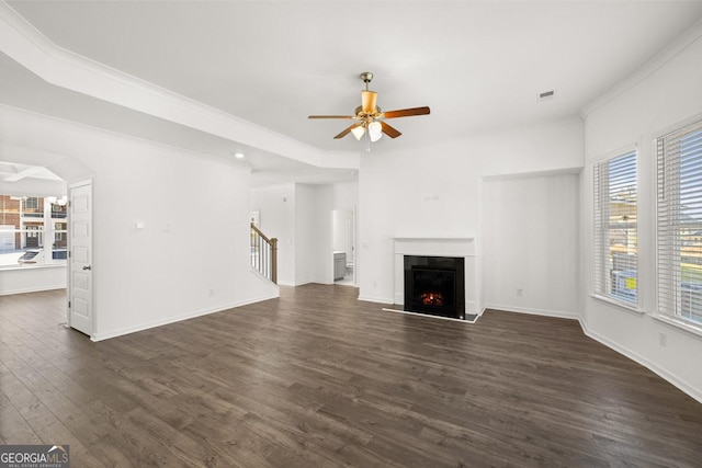683 Edgar, Hampton, GA 30228 - unfurnished living room featuring a ceiling fan, dark wood-style floors, a warm lit fireplace, ornamental molding, and recessed lighting