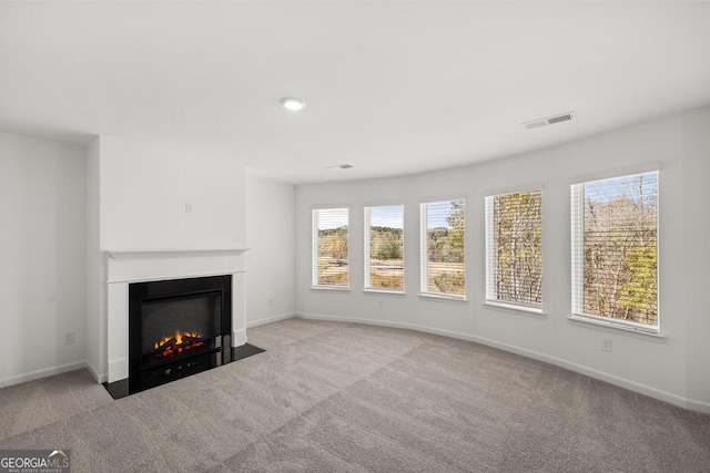 683 Edgar, Hampton, GA 30228 - unfurnished living room with carpet and a fireplace with flush hearth