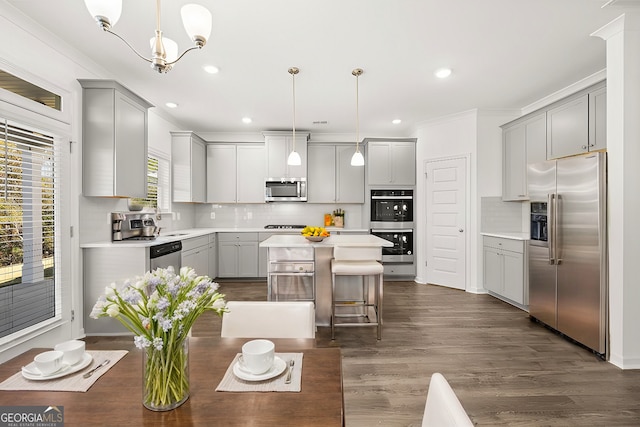 683 Edgar, Hampton, GA 30228 - kitchen featuring stainless steel appliances, gray cabinets, crown molding, a center island, and backsplash