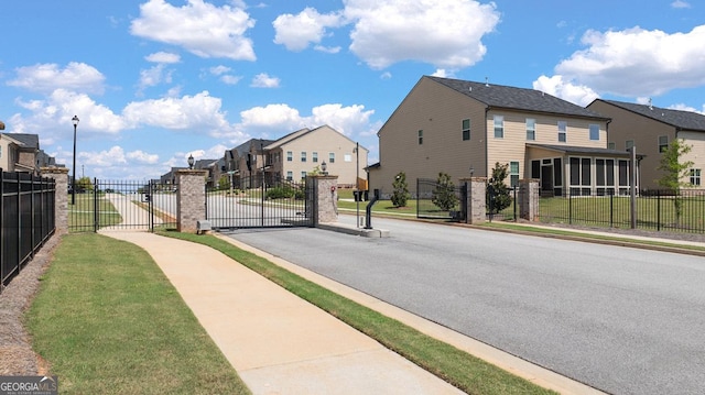 683 Edgar, Hampton, GA 30228 - view of asphalt street featuring sidewalks, a gate, and a residential view