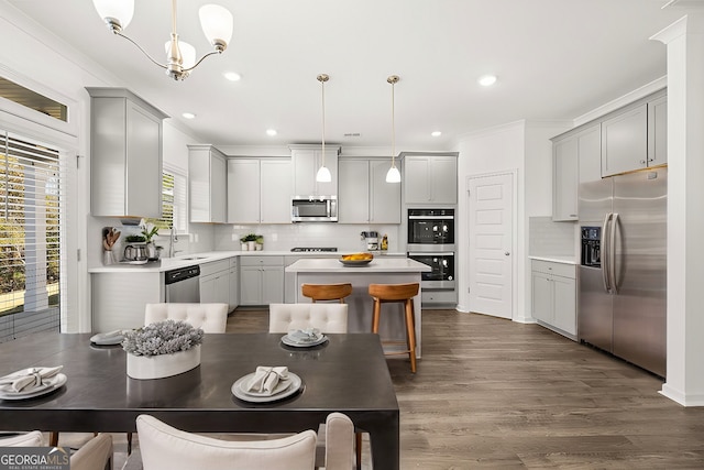 683 Edgar, Hampton, GA 30228 - kitchen with appliances with stainless steel finishes, gray cabinets, a center island, tasteful backsplash, and crown molding