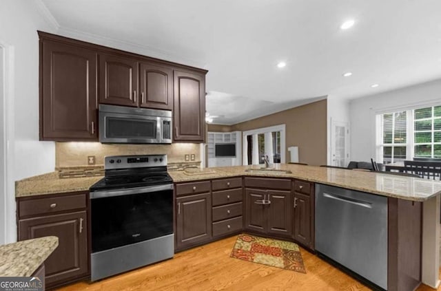 3737 Falls Trl, Winston, GA 30187 - kitchen featuring stainless steel appliances, dark brown cabinetry, light wood-style floors, recessed lighting, and light stone counters